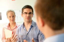 Researchers interacting with staff