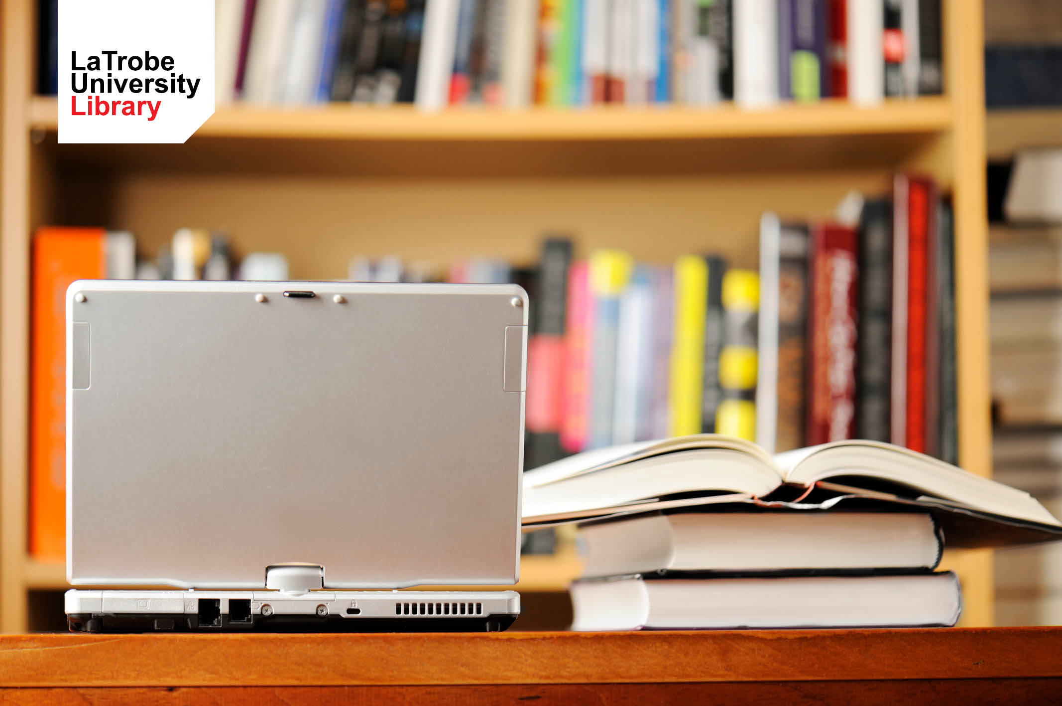 Laptop computer and books in a library