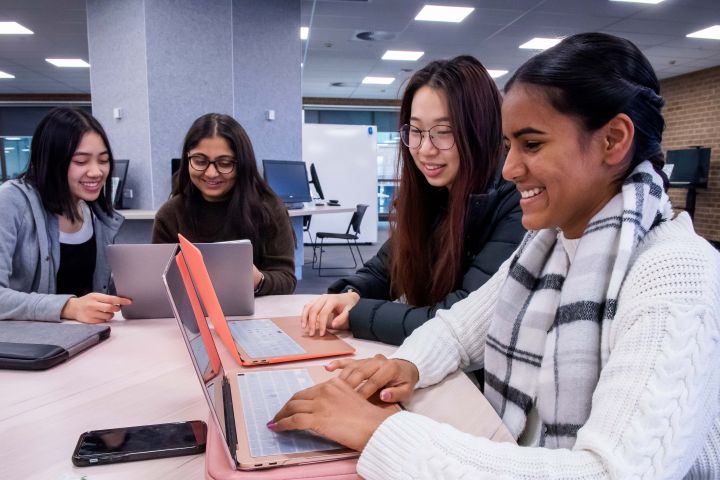 Students using laptops in the Bendigo campus library.