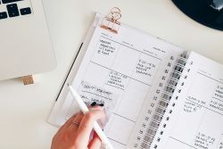 Person writing in a planner