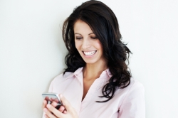 Photo of a woman looking at her iphone